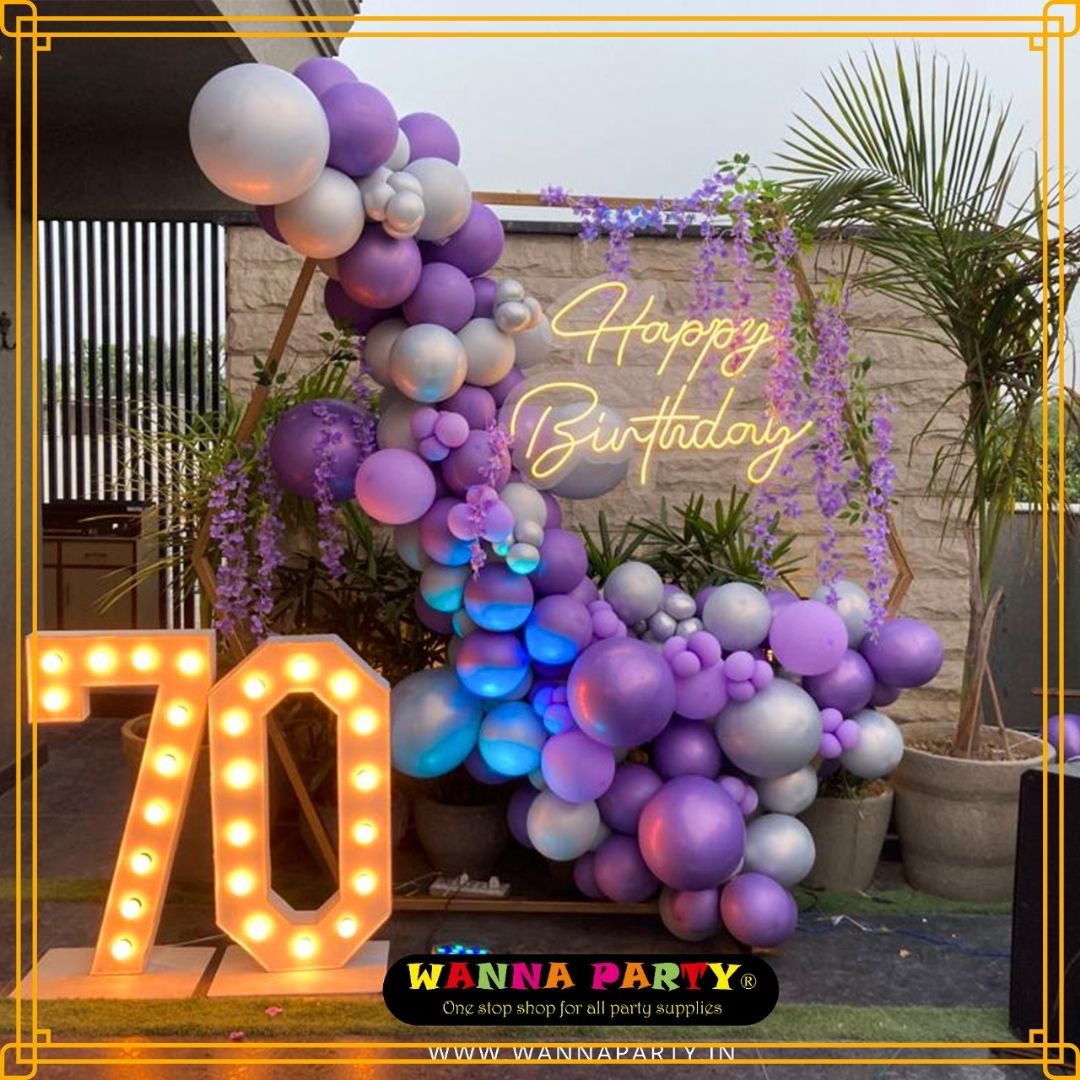 70th Birthday Hexagon Set Up with Uplighters and Flowers