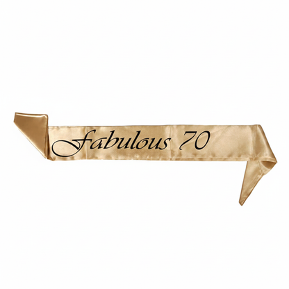 Flat lay of golden satin Fabulous 70 sash on white background