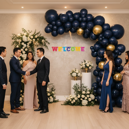 Colorful Welcome letter banner hung on wall at indoor party venue with balloon arch