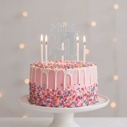 Happy 21st silver glitter acrylic cake topper on pink birthday cake with white frosting and candles