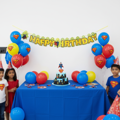 Superman Happy Birthday banner hung on wall at kids Superman themed birthday party with blue red balloons